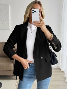 Classic black notch lapel blazer for women paired with a white turtleneck and blue jeans