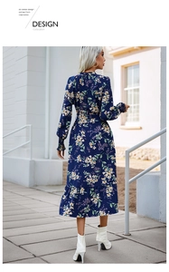Rear view of floral long-sleeved midi dress featuring a cinched waist and ruffled hemline