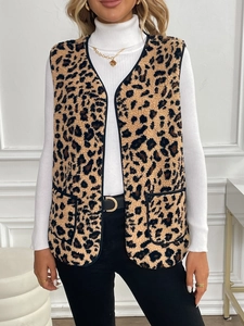 Close-up of leopard print plush vest with black trim and large functional side pockets