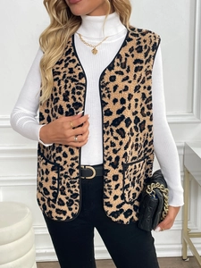 Detail of leopard print fleece vest featuring black trim and functional side pockets