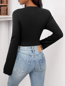 Rear view of black long sleeve ribbed bodysuit paired with high waist light blue denim jeans