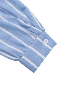 Close-up of the buttoned cuff and vertical blue stripes on cotton-linen blend shirt