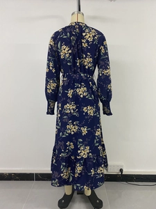 Rear view of floral long sleeve maxi dress with tiered ruffle hem and tie waist detail