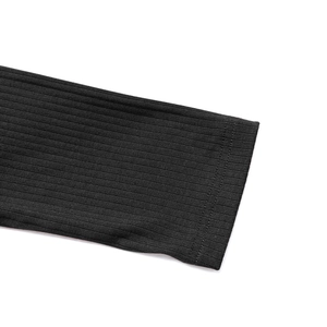 Detail of black ribbed knit fabric showing high-quality double stitching on the sleeve cuff