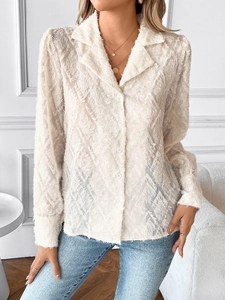 Close-up of cream white long sleeve blouse featuring unique fringe textured feather fabric