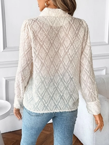 Detailed view of white long-sleeve shirt with luxury textured diamond jacquard fabric