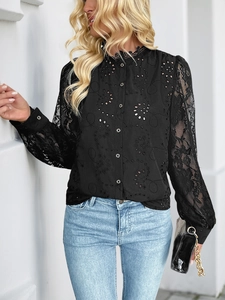 Detailed close-up of intricate lace patchwork and hollow floral embroidery on a black shirt