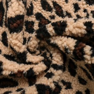 Close-up of soft leopard print plush fabric showing the thick warm texture of the vest