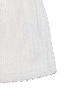 Close-up of white ribbed knit fabric showing the detailed texture and high-quality hem stitching