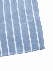 Macro shot of blue and white striped cotton fabric texture with neat stitching details