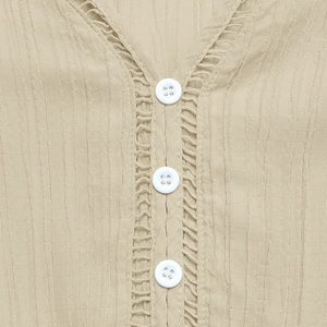 Detailed view of khaki V-neck dress featuring textured crepe fabric and hollow lace trim