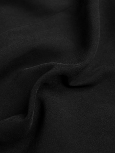 Macro shot of high-quality black twill fabric texture for elegant blazer and suit