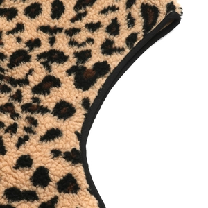 Close-up of leopard print faux fur texture with high-quality black stitched fabric edging
