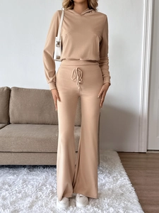 Detail view of almond ribbed knit lounge set featuring hooded top and flared trousers