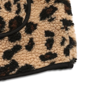 Detail of leopard print fleece vest showing plush texture and black piped edge finishing