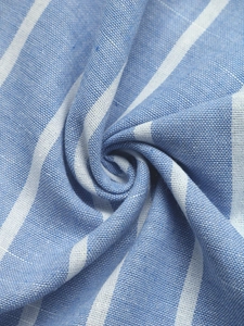 Detailed macro view of the blue and white vertical striped fabric texture and cotton weave