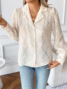 Detail of beige long-sleeve shirt featuring unique 3D fringe texture and classic white buttons