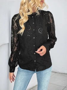 Detail of elegant black lace hollow out embroidery and silver ring buttons on long sleeves