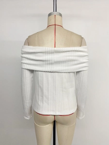 Close-up of the ribbed texture and fold-over off-the-shoulder neckline on white top