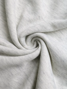 Close-up of soft grey knitted cotton blend fabric with elastic texture and spiral fold