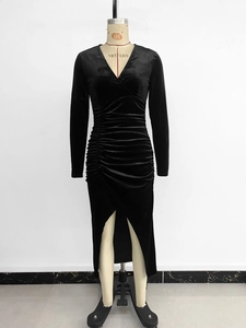 Detail of elegant black velvet V-neck midi dress with side ruching and a side slit