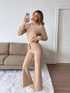 Detailed texture of beige ribbed knit hoodie and flare pants loungewear set for women