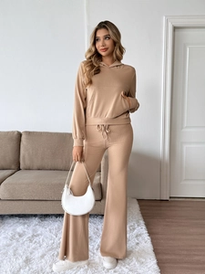 Detail of khaki knitted two-piece set featuring hooded sweatshirt and drawstring flared pants