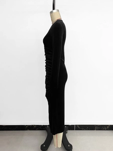 Close-up of ruched side detail on a black long sleeve bodycon midi velvet dress