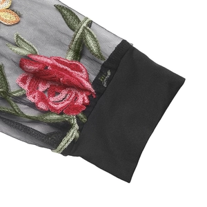 Detailed view of floral embroidery on sheer mesh sleeves with ribbed cuffs