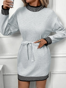 Detail view of the striped cuffs and knit texture of a high-neck long-sleeve grey dress