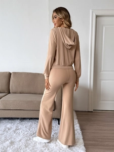 Detail of ribbed knit texture on apricot hooded sweatshirt and flared pants set