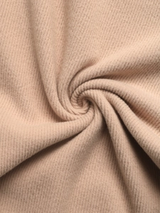 Macro shot of khaki ribbed knit fabric showing soft texture and vertical striped pattern