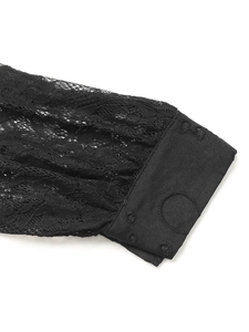 Detailed macro view of black hollow lace embroidery on the elegant shirt sleeve
