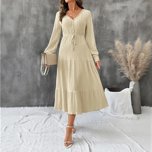 Beige V-neck long sleeve tiered maxi dress with textured fabric and drawstring waist