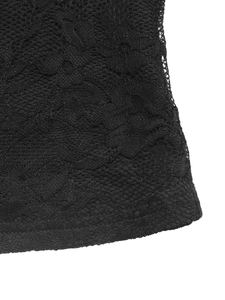 Close-up of black floral lace fabric with intricate mesh structure on a V-neck top
