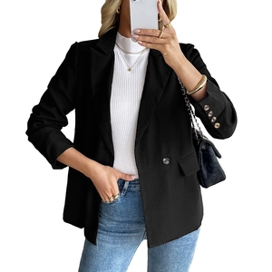 Women's professional black blazer with gold buttons and a white knit sweater