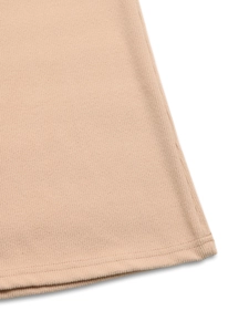 Close-up of beige ribbed knit fabric hem with high-quality double-needle stitching details