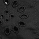 Detailed macro view of black lace hollow embroidery and eyelet texture on fabric