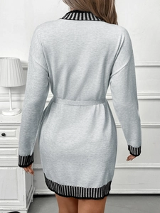 Detailed back view of a grey knitted dress with chic black and white striped ribbed edges