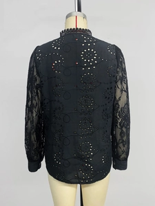 Detailed back view of a black lace hollow-out embroidered long sleeve shirt with lace cuffs