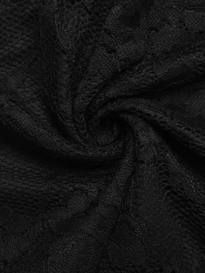 Macro shot of black lace fabric detailing with intricate floral patterns and hollow texture