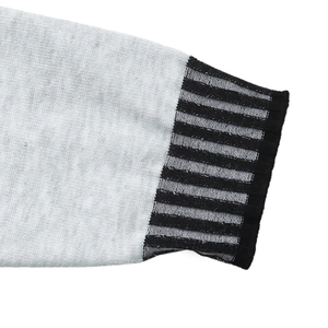 Close-up of light grey knit dress cuff with black striped ribbed texture details