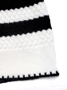 Macro shot of black and white striped cable knit texture with detailed ribbed edge