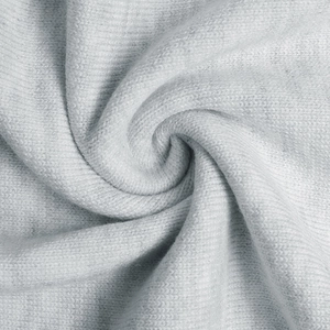 Macro view of light gray knitted fabric texture for long-sleeved winter dress