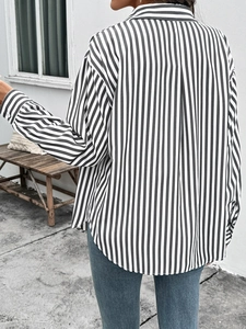 Back view of a women's lightweight black and white striped long sleeve casual shirt