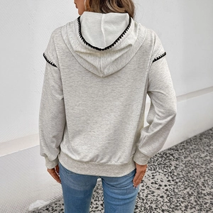 Back view of gray oversized hoodie with contrast black stitching and ribbed cuffs
