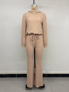 Detail of rib-knit apricot hoodie and high-waist drawstring trousers on a mannequin