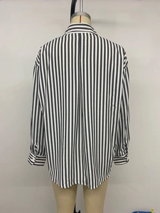 Detailed back view of casual black and white striped shirt with curved hem for women