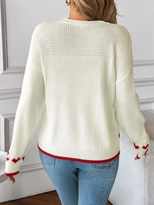 Back view of women's white knit sweater featuring red heart patterns and striped hem