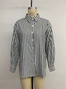 Detailed view of women's long sleeve striped shirt featuring lapel collar and button closure
